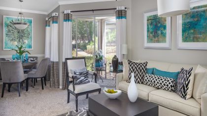Modern-style living room with sliding doors to patio at MAA Heathrow luxury apartments in Orlando, FL