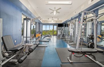 Fitness room with treadmills and weight machines at Market Station luxury apartments in Kansas City, MO