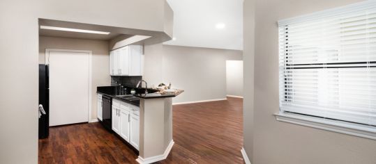 Kitchen and living space at MAA Park Mesa luxury apartment homes in Austin, TX