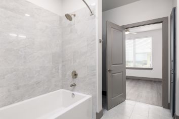 Bathroom with tub at MAA Windmill Hill Luxury Apartments in Austin, TX