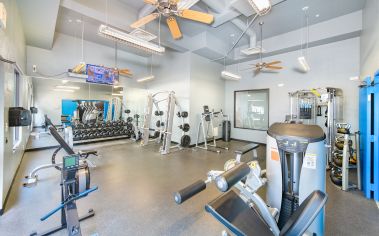 Fitness center with weight machines and free weights sections at MAA Heights luxury apartments in Dallas, TX