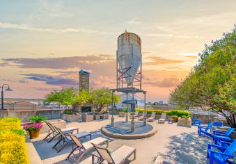 Rooftop terrace with lounge seating during sunset at MAA Heights luxury apartments in Dallas, TX