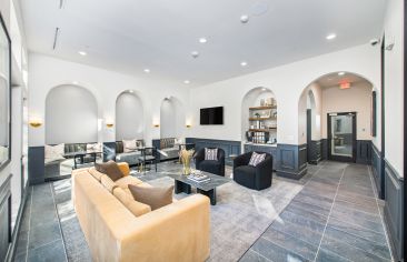 Modern community clubhouse and leasing office with large lounge sitting area and coffee station at MAA Legacy luxury apartments in Plano, TX