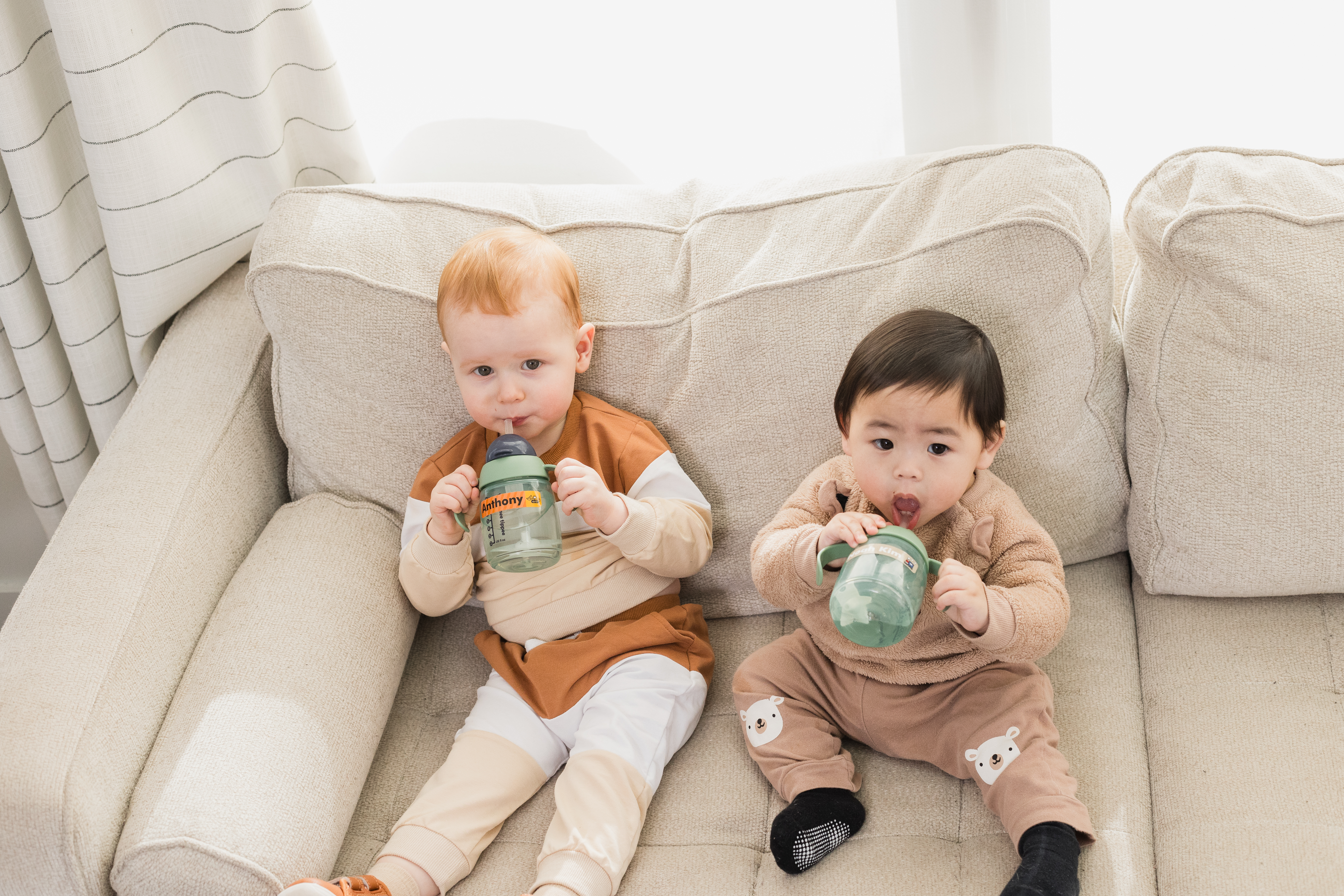 Two preschoolers with Mabel's Labels on their sippy cups