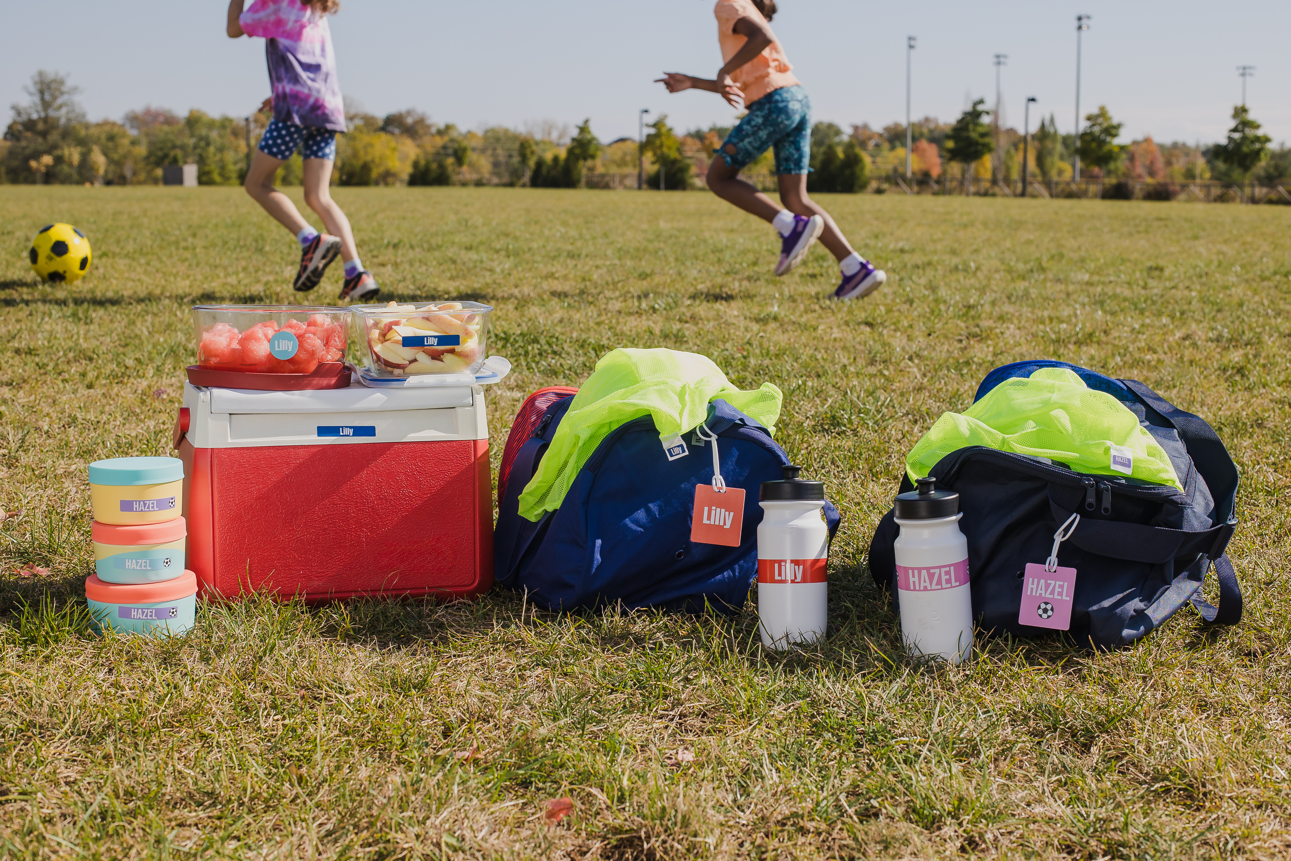 Mabel's Labels on equipment bags, water bottles, a cooler and food containers at a soccer game