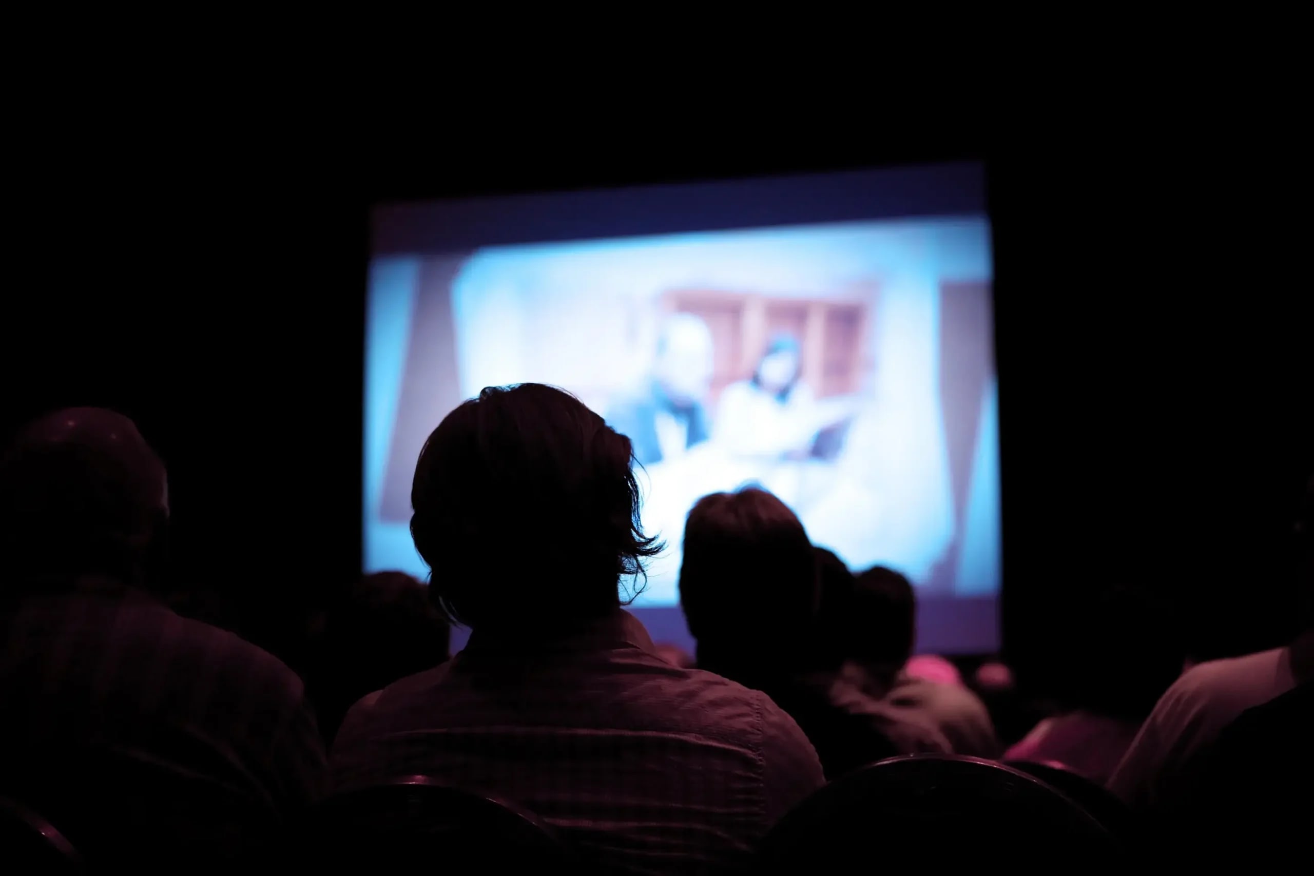 A man in watching a movie in cinema