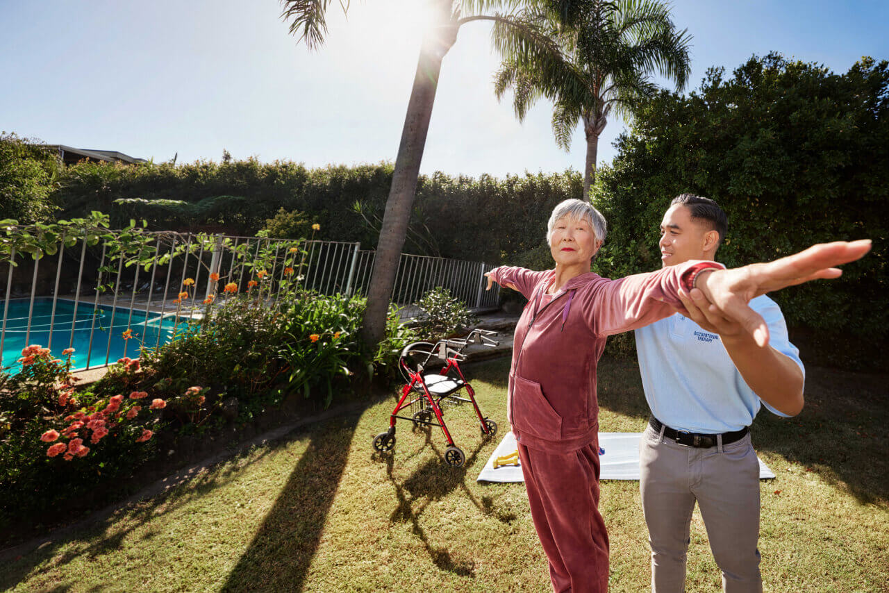 Physiotherapist working with a Mable client in the garden.
