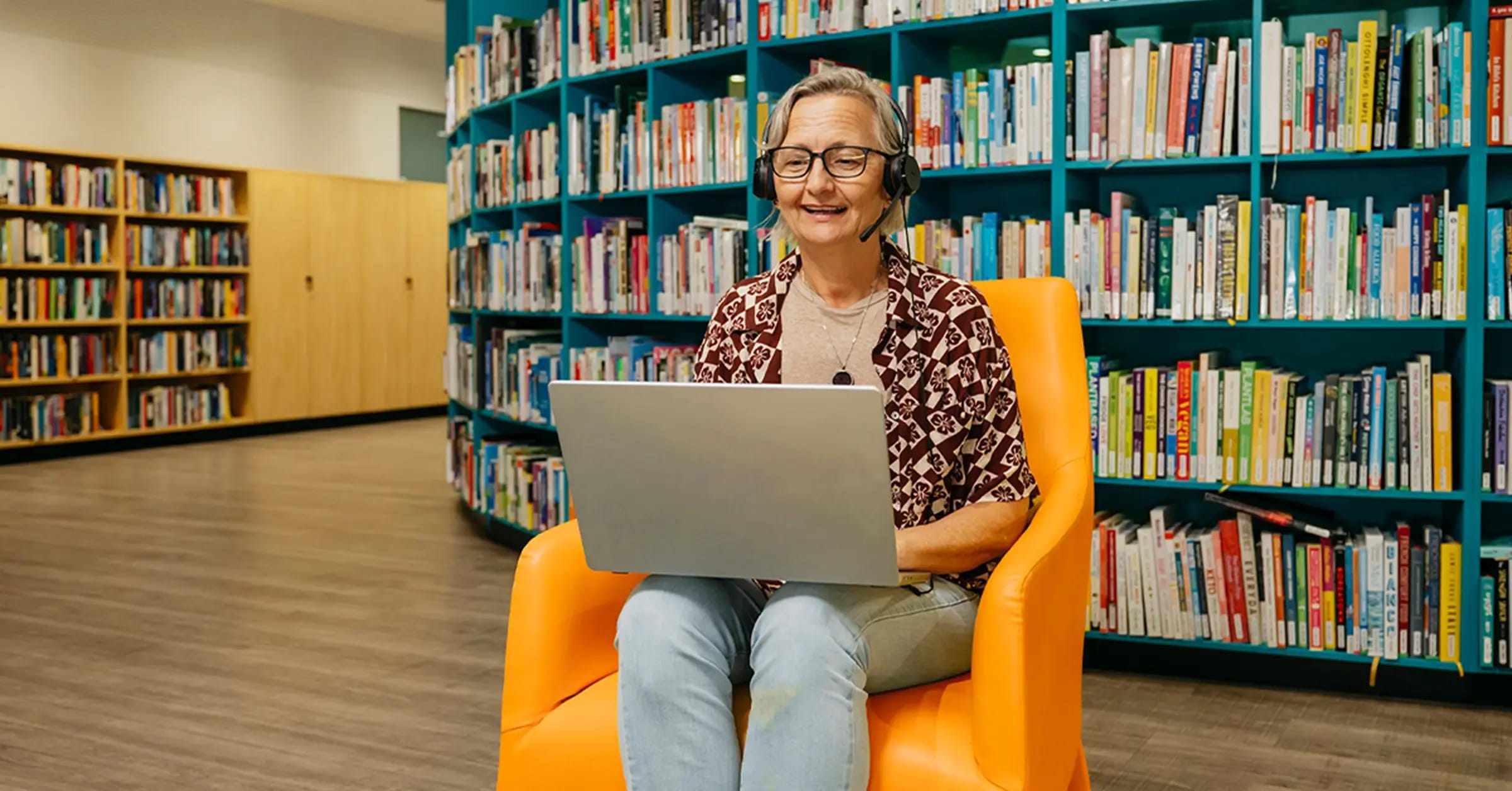 Support coordinator with laptop and headset searches support workers on Mable for their clients.