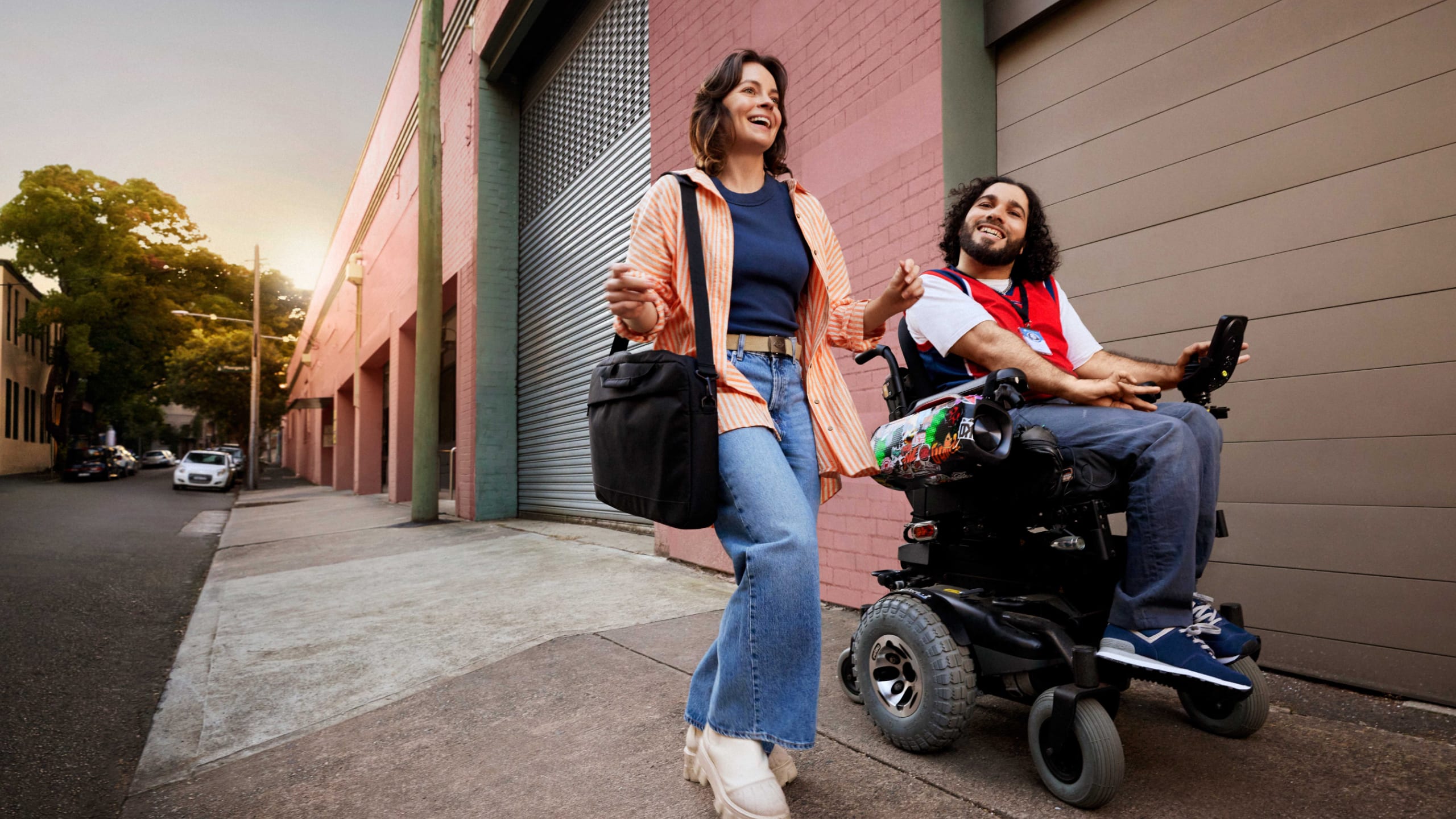 In an wheelchair, on their way to work with support worker.
