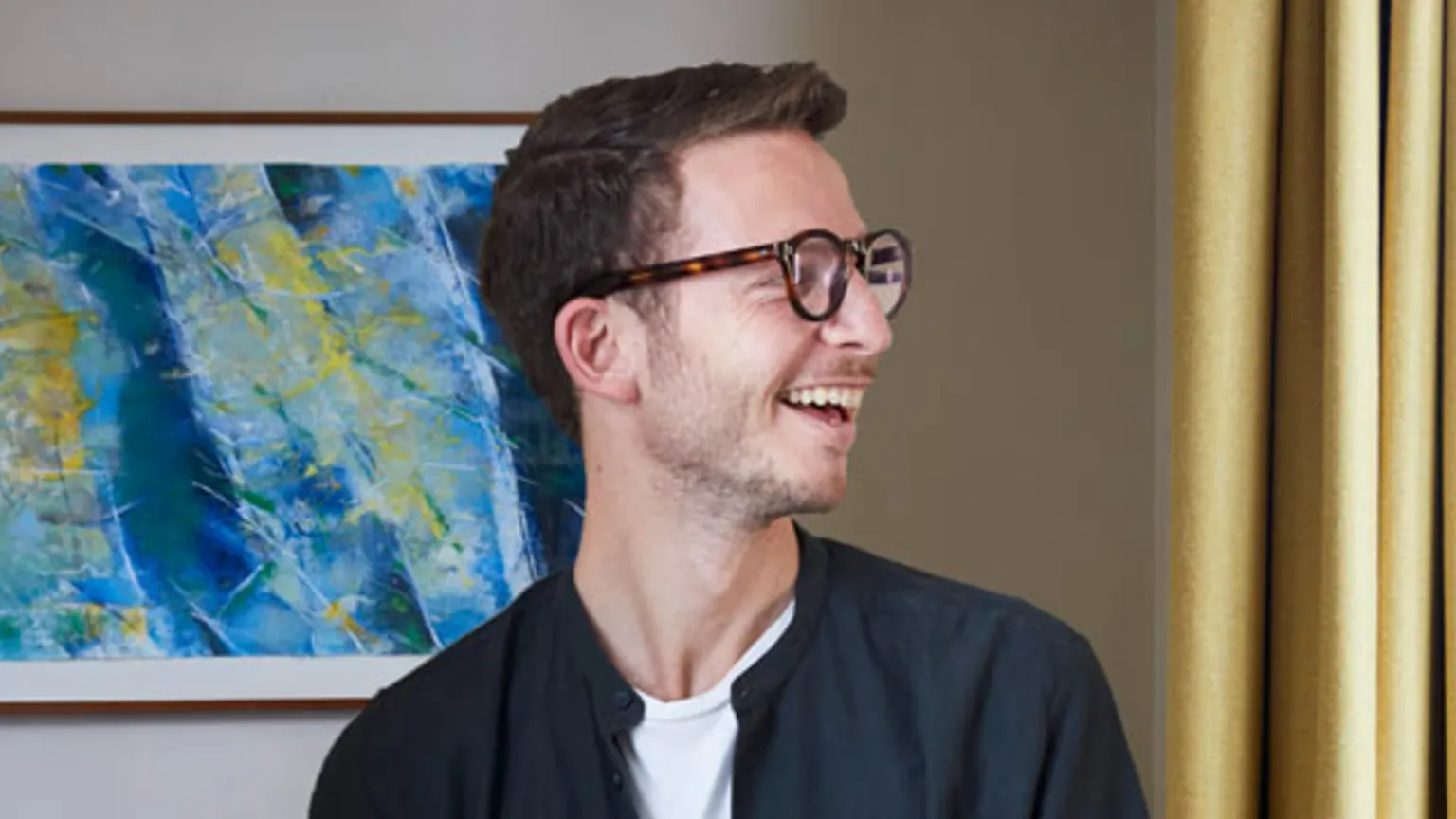 customer portrait smiling with yellow bay window curtains