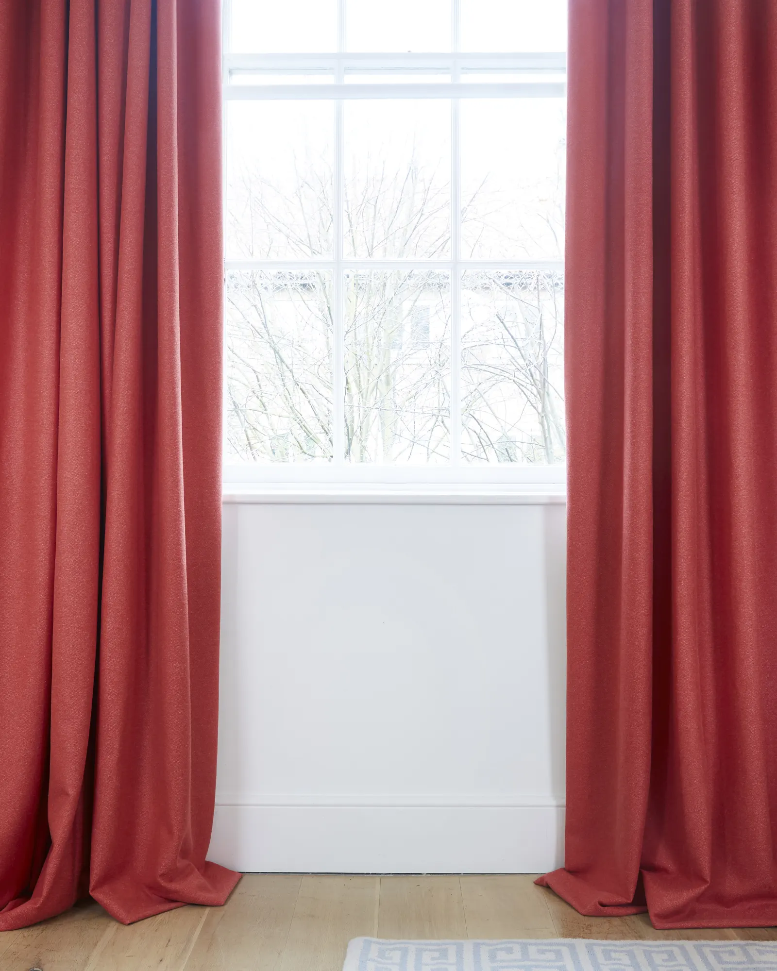 Long red curtains with pooling