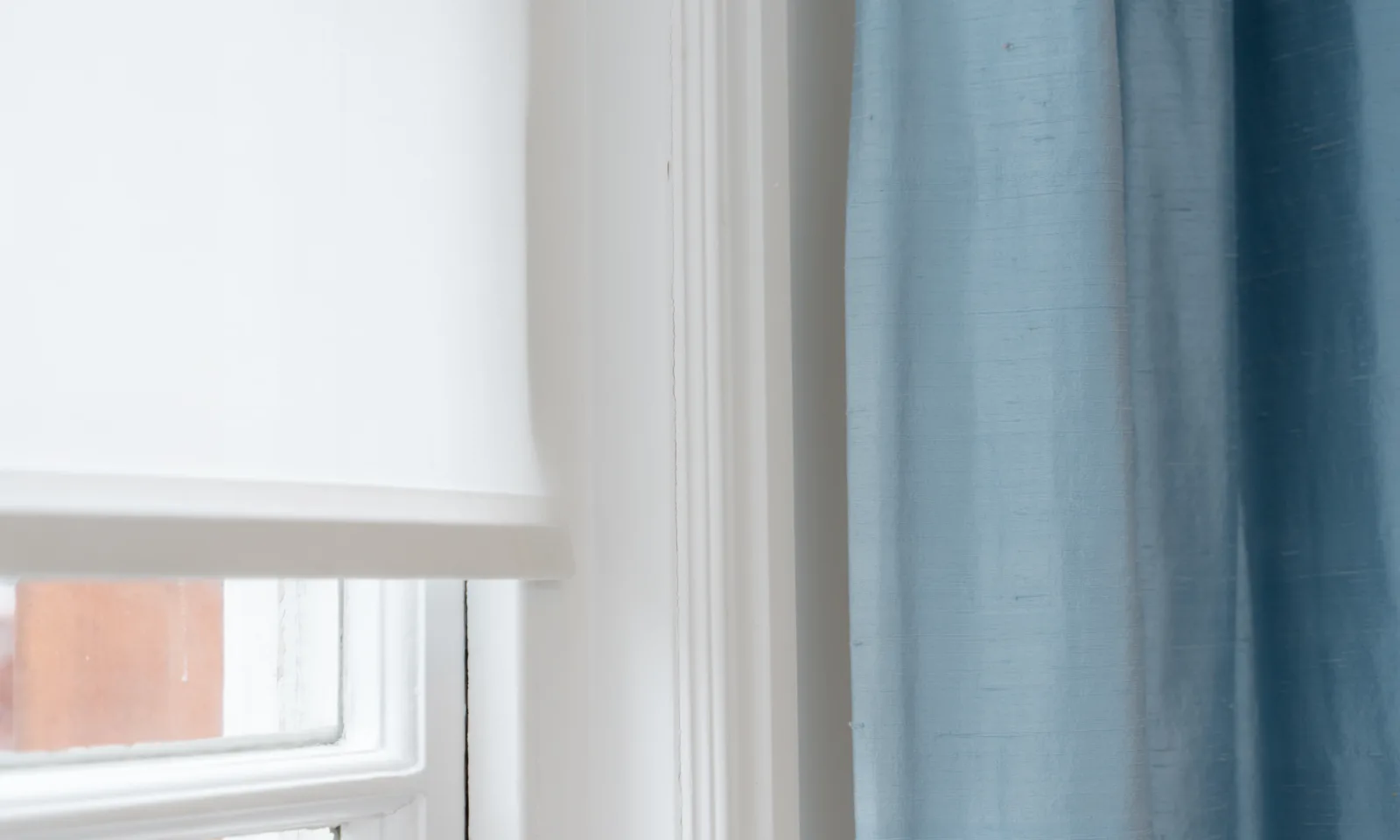 blue silk curtains and roller blind in living room