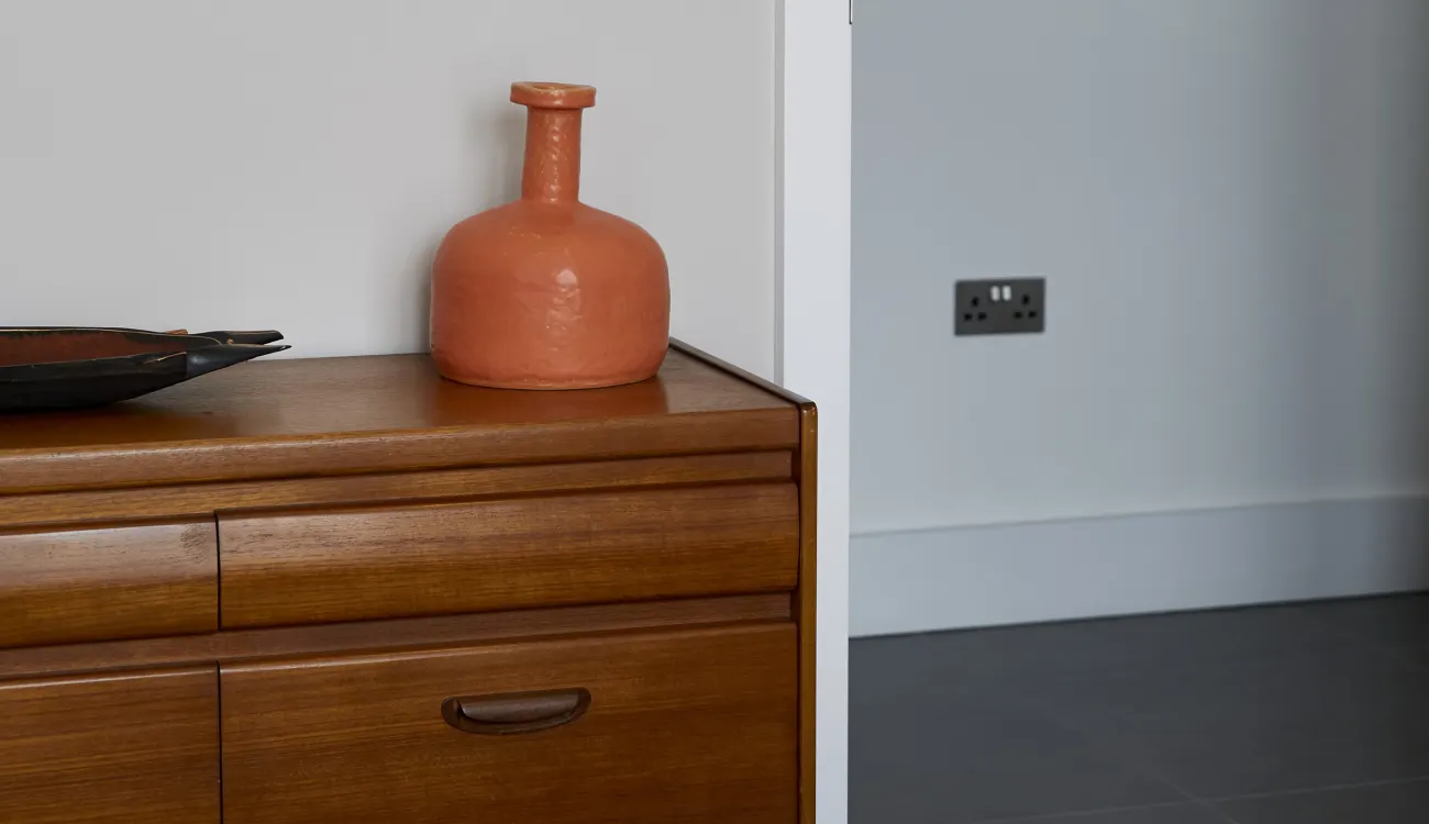 orange vase on drawers