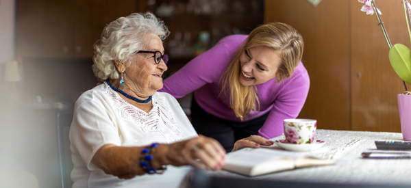 Woman helping elderly woman