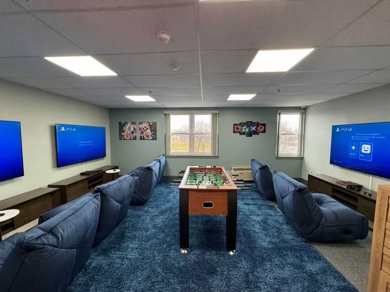 Recreation room with gaming stations and foosball table