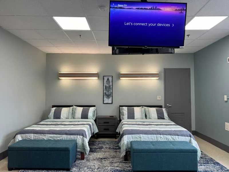 Comfortable residential bedroom with twin beds and modern amenities