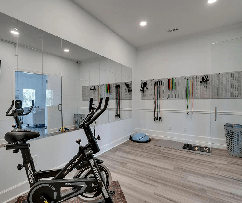 Fully equipped fitness room with exercise equipment and mirrors