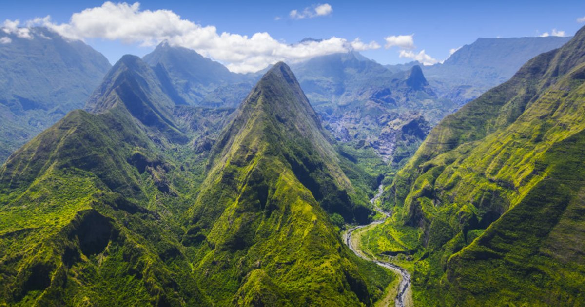 Hikers in the Mafate cirque with a local guide, a view over the îlets and ramparts of the cirque, Reunion Island