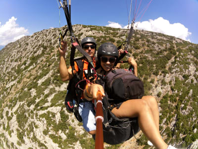 Tandem paragliding flight over the archeological site of Delphi