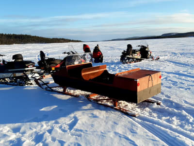 Ice Fishing Excursion by Snowmobile and Sleigh on the Ivalo River from Ivalo