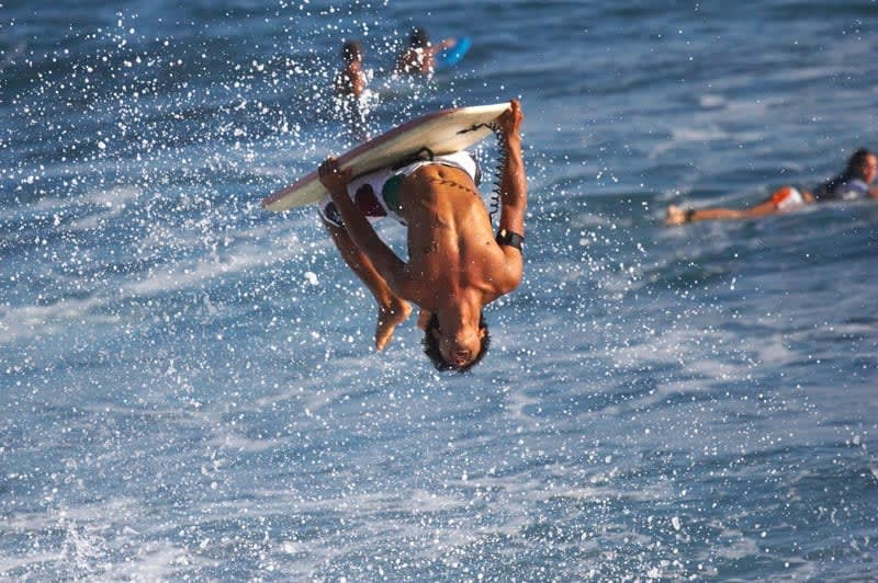 Man upsidedown on a board