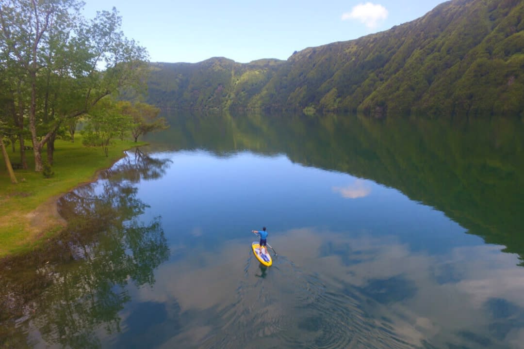 A person douing a Stand Up Paddle Lesson in the Lake of Sete Cidades in São Miguel Island, Azores
