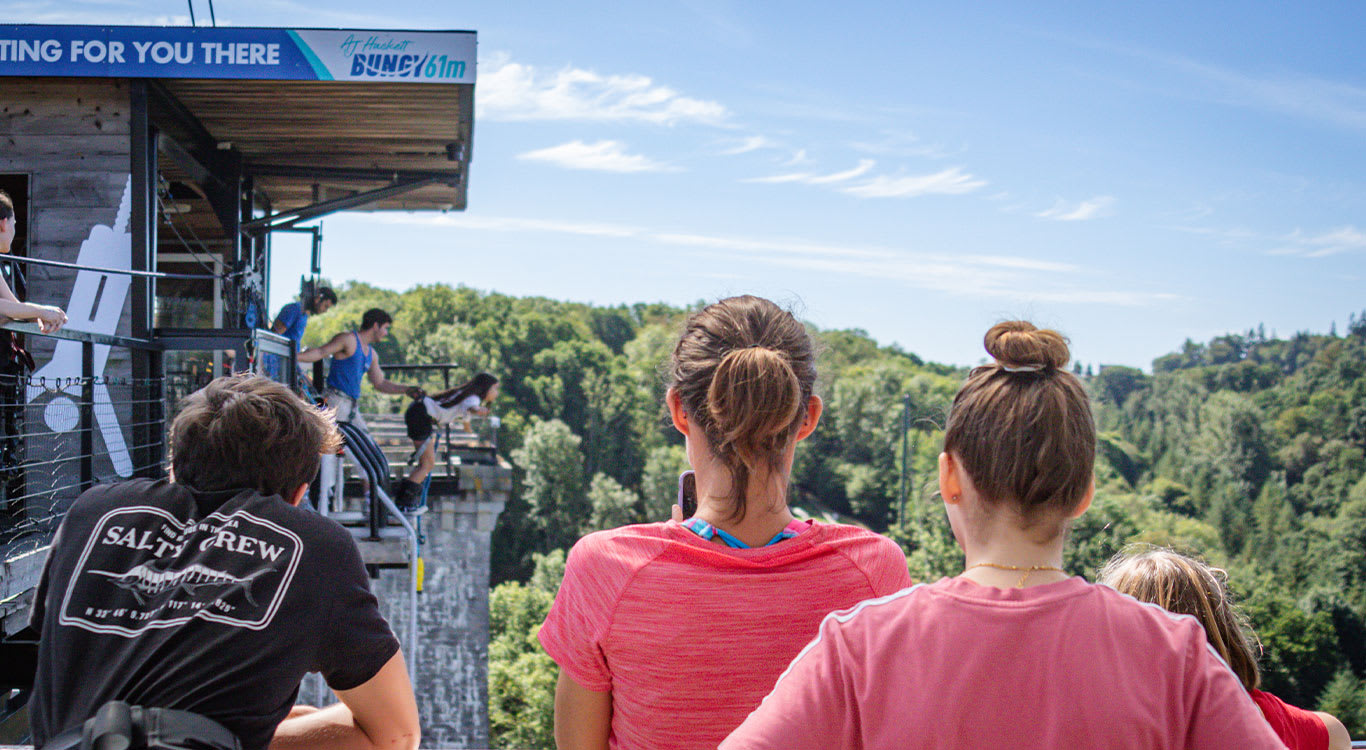 People taking photos of a girl bungee jumping at SkyPark Normandie