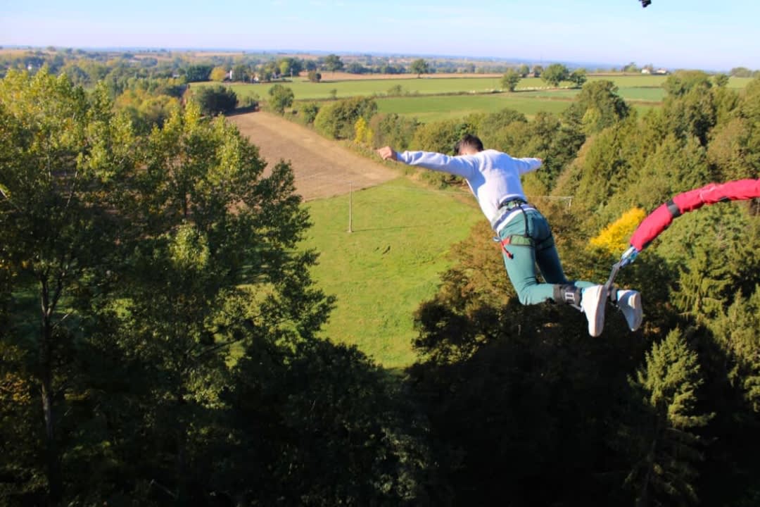 A man doing bungee jumping from the Viaduc de Pelussin