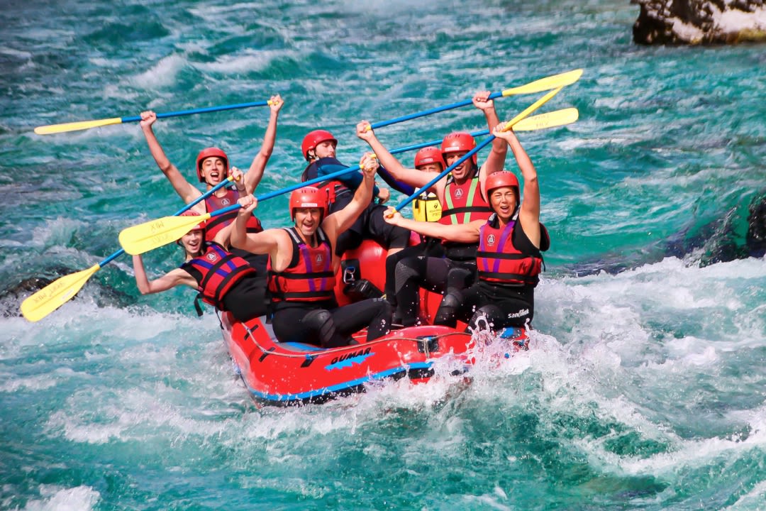Friends doing rafting on Soča River from Bovec