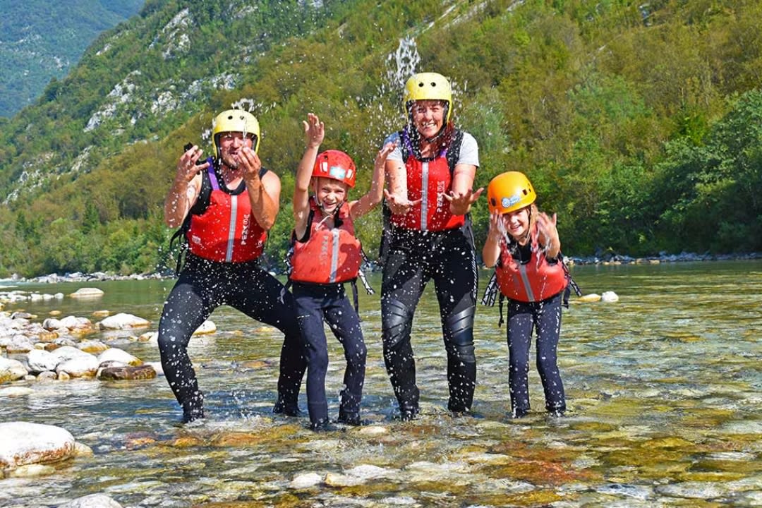 Family enjoying a Rafting excursion on the Soča River in Bovec