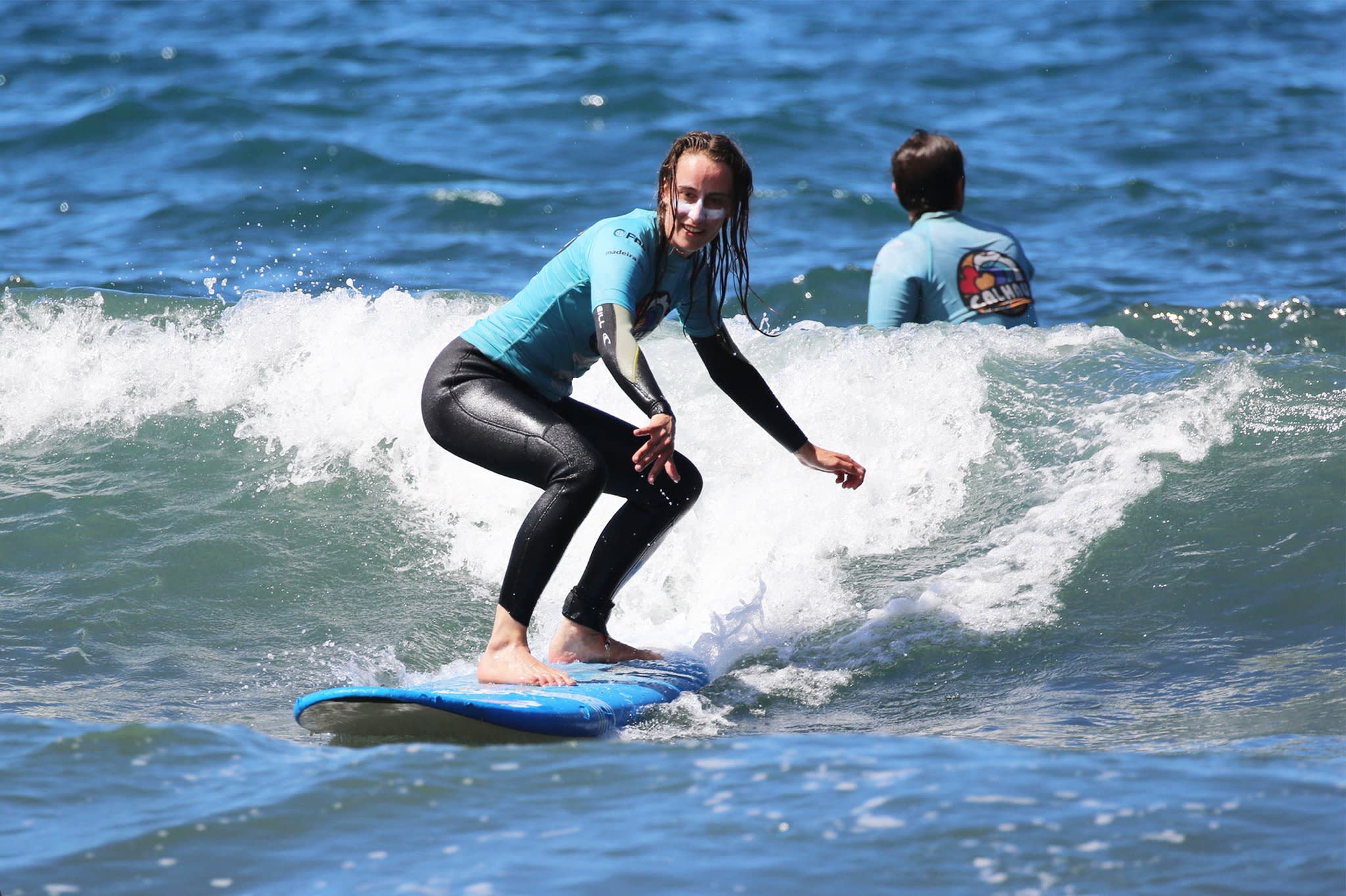 Woman surfing in Porto da Cruz near Santana, Madeira