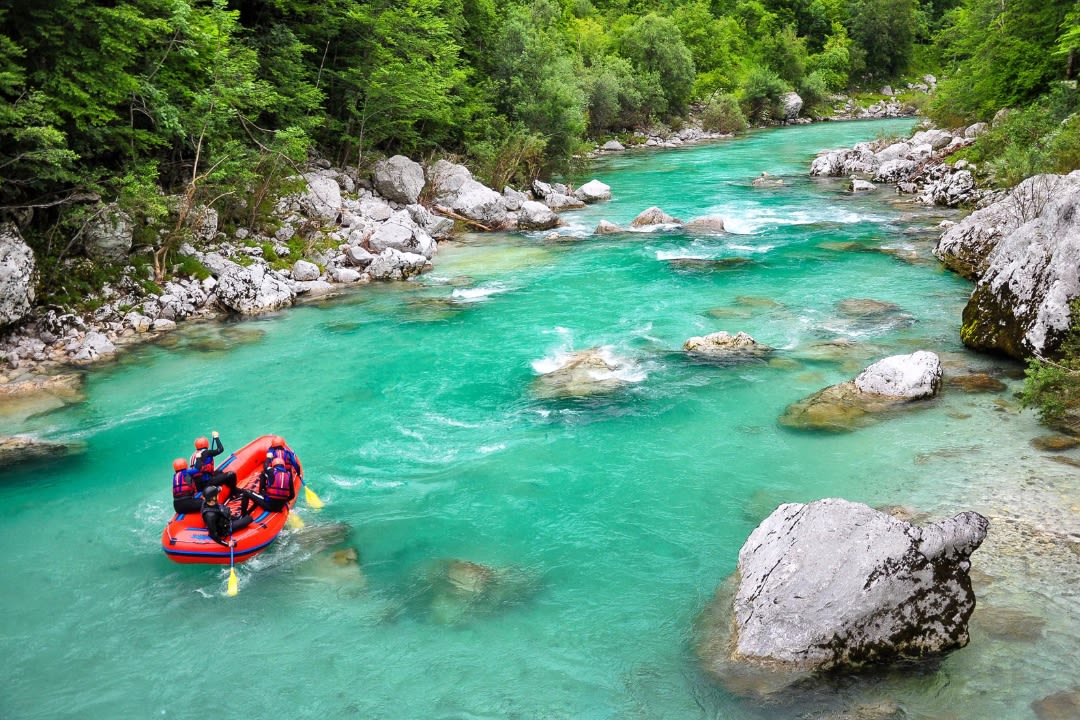 Friends doing rafting on Soča River from Bovec