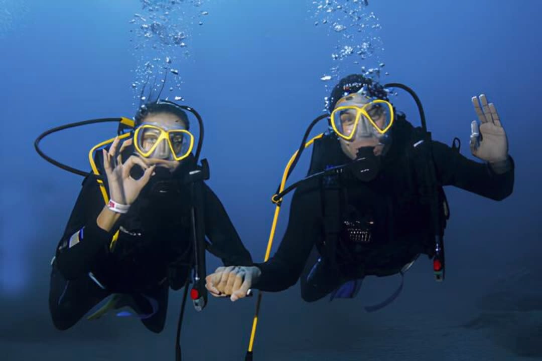 A couple doing PADI Scuba Diving Course on the island of Faial, Azores