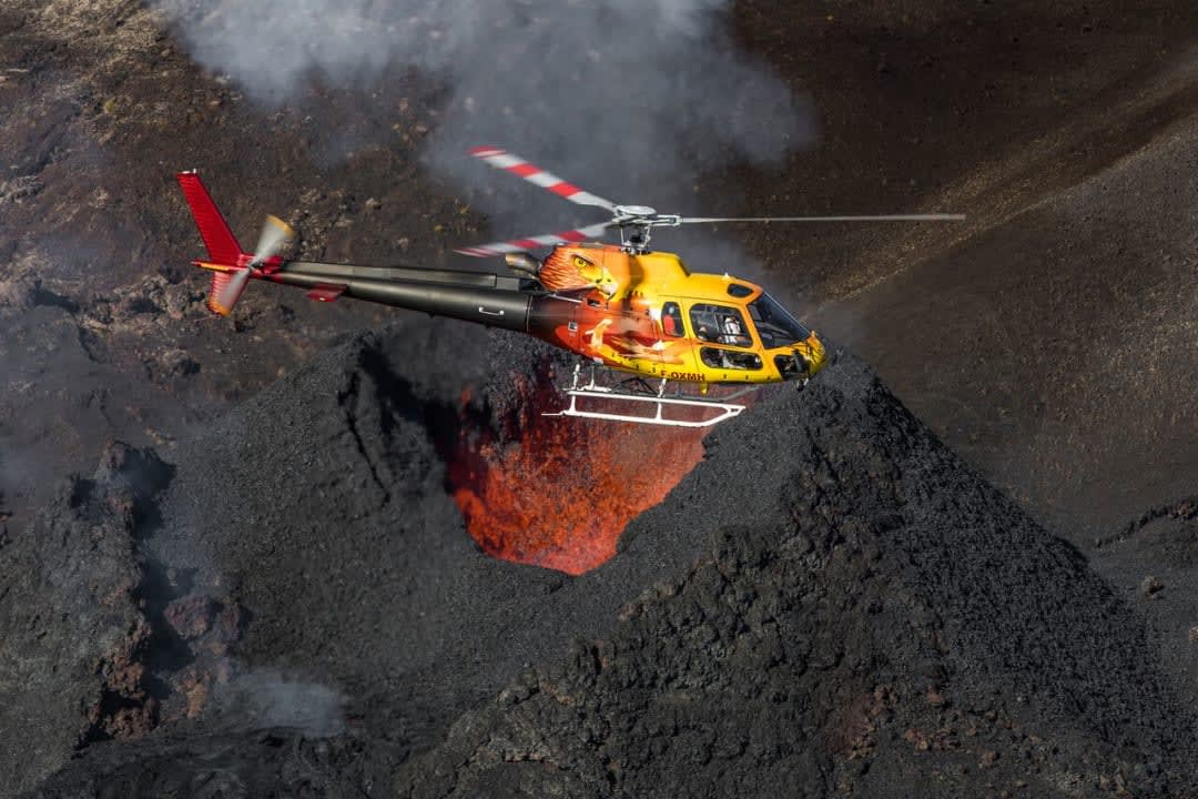 helicopter flying over Piton de la Fournaise on Reunion Island