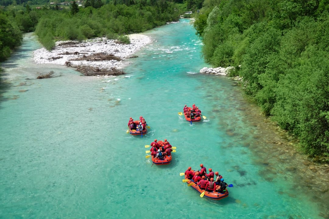 Friends doing rafting on Soča River from Bovec
