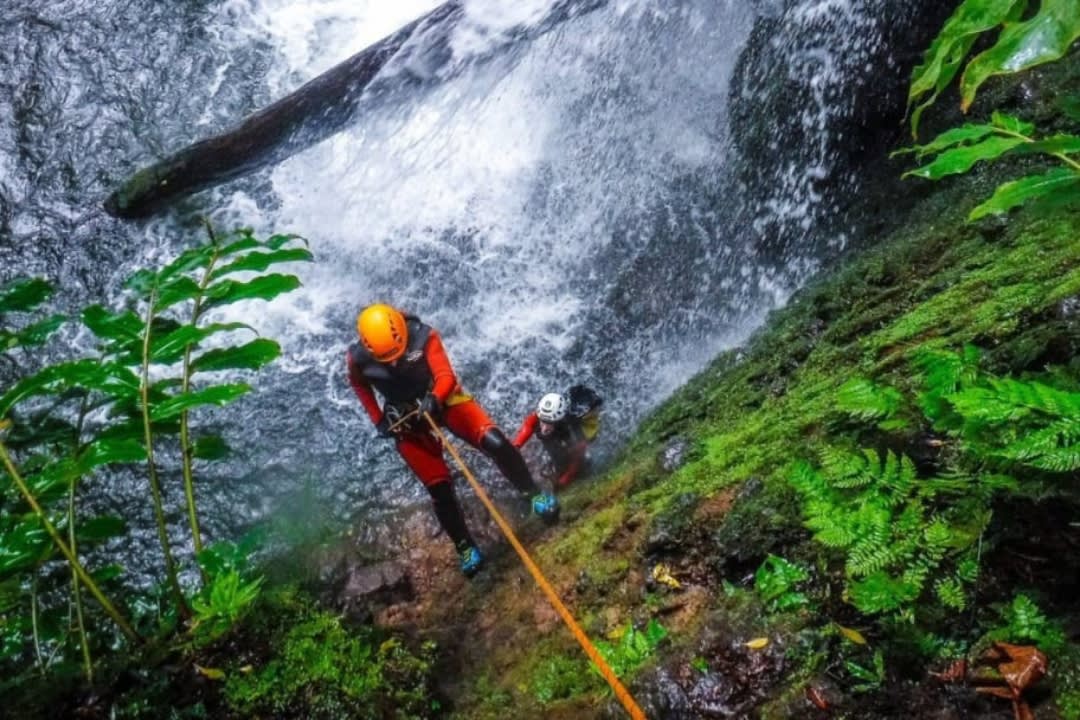A man Canyoning Down the Ribeira dos Caldeiroes in São Miguel, Azores