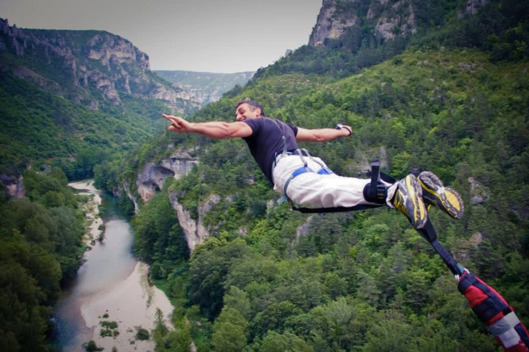 a man doing bungee jumping in the Gorges du Tarn near Millau