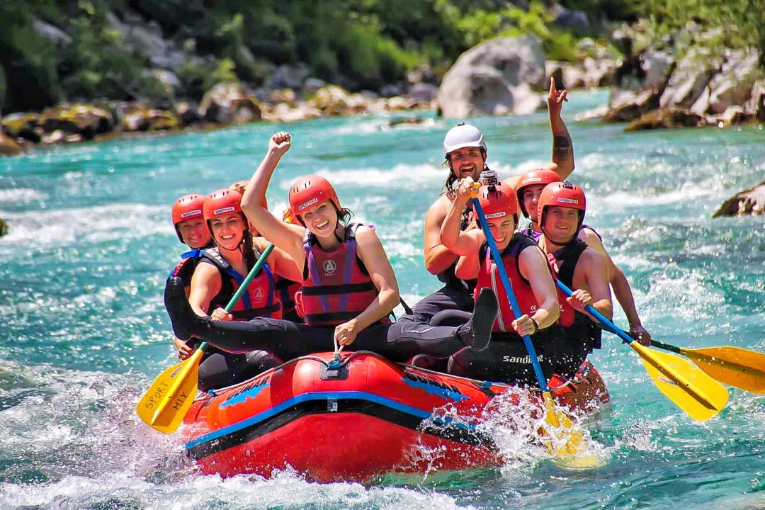Friends doing rafting on Soča River from Bovec