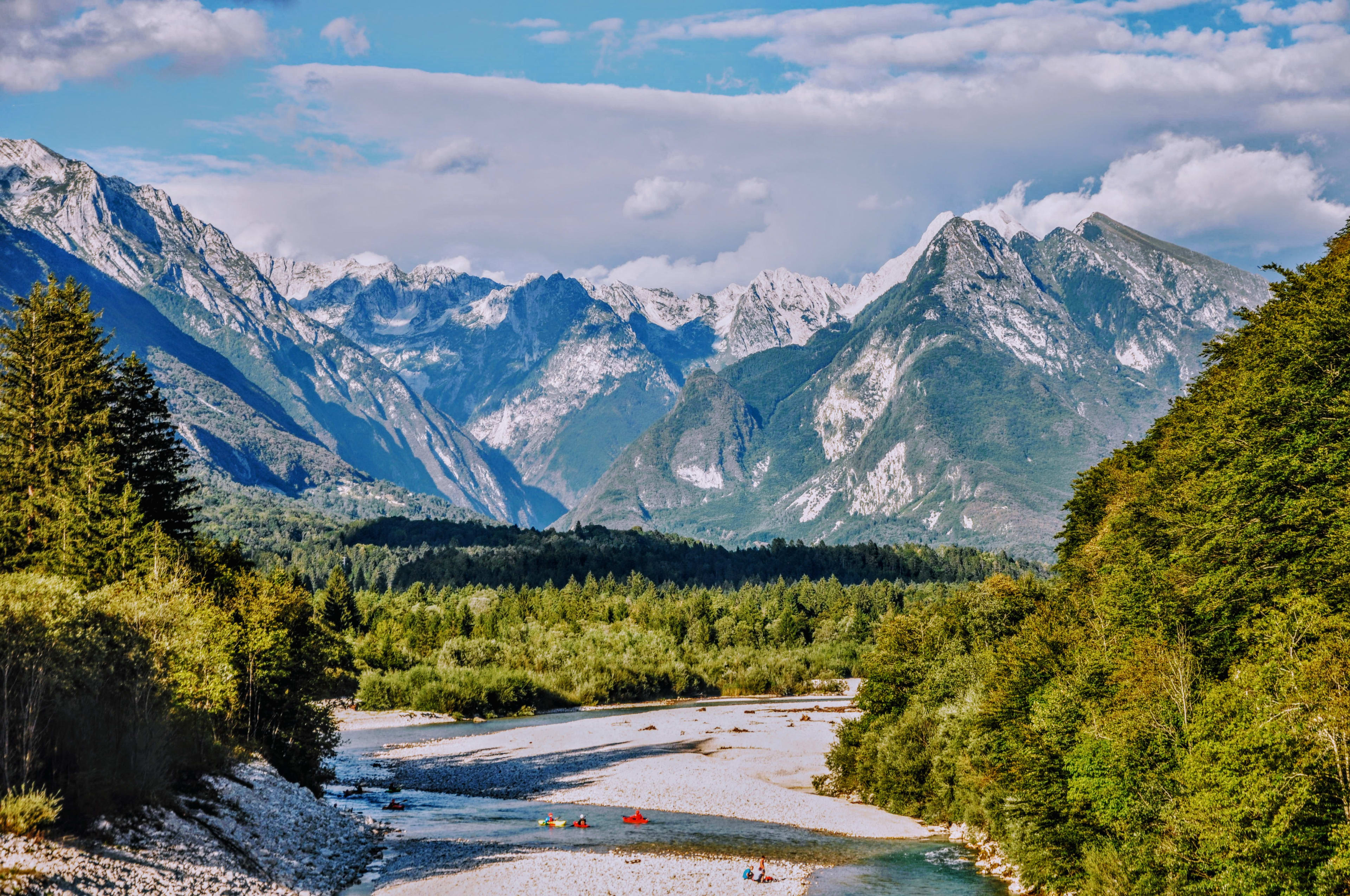 kayaking on the Soča River with view on Julian Alps