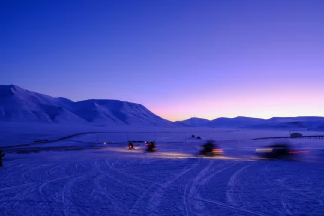 Blue Light Snowmobile Trip through Svalbard in Spring