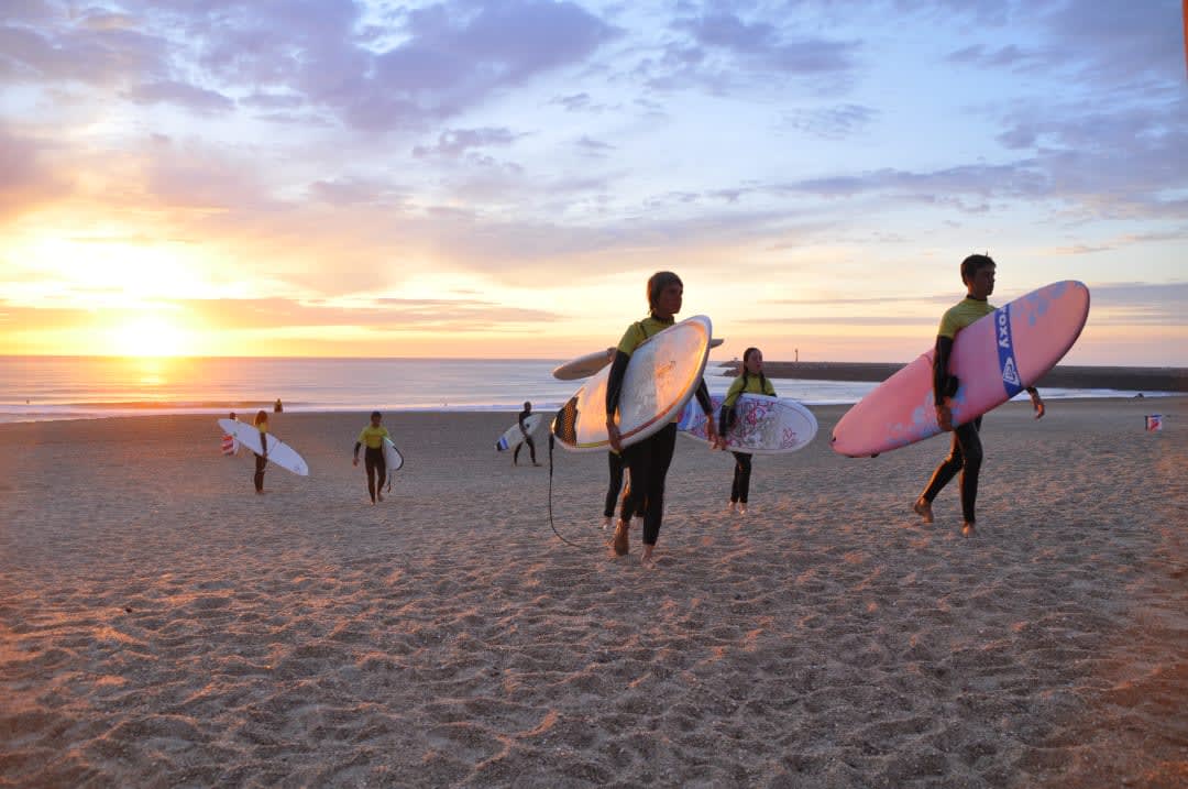 A group of friends enjoying a surfing class in Anglet