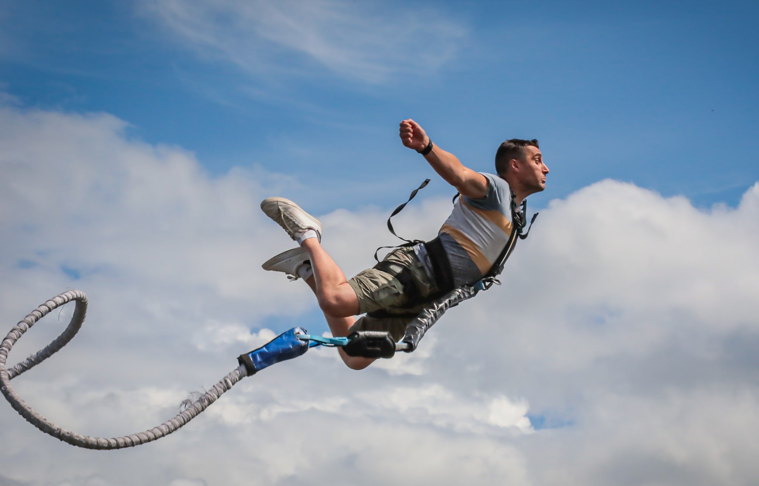 Man bungee jumping from the Souleuvre Viaduct in Normandy