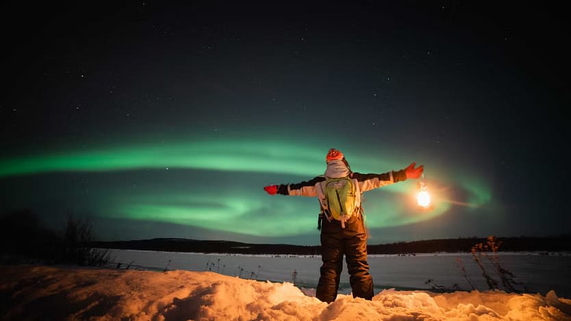 Man admiring northern lights from Levi
