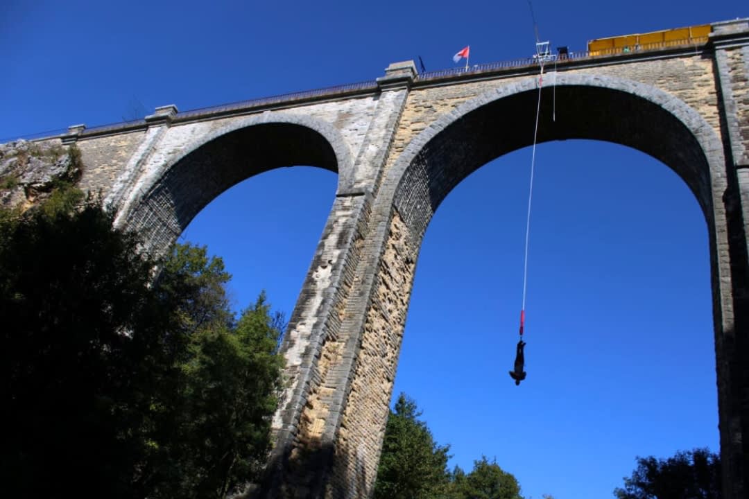 A man doing bungee jumping at the Coquilleau Viaduct near Nantes