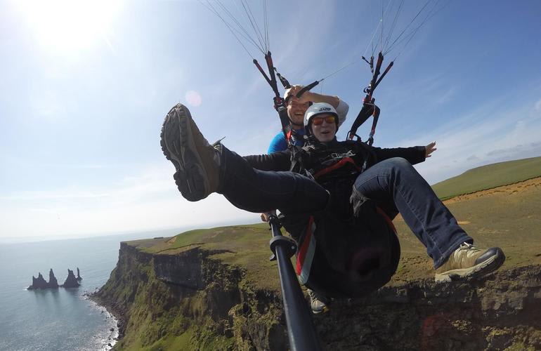 Tandem Paragliding flight over the cliffs at Vik i Myrdal