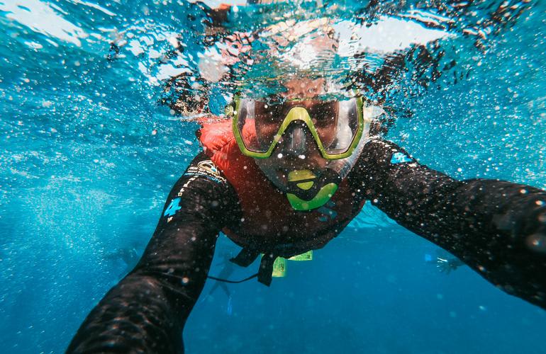 Snorkeling in the clear waters of Santorini