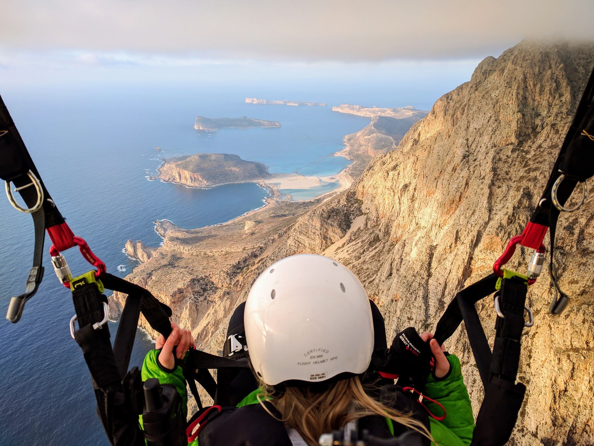 People Gliding above Crete Island in Greece