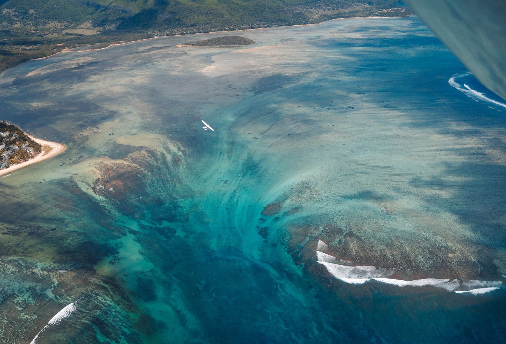 Seaplane over the underwater waterfall