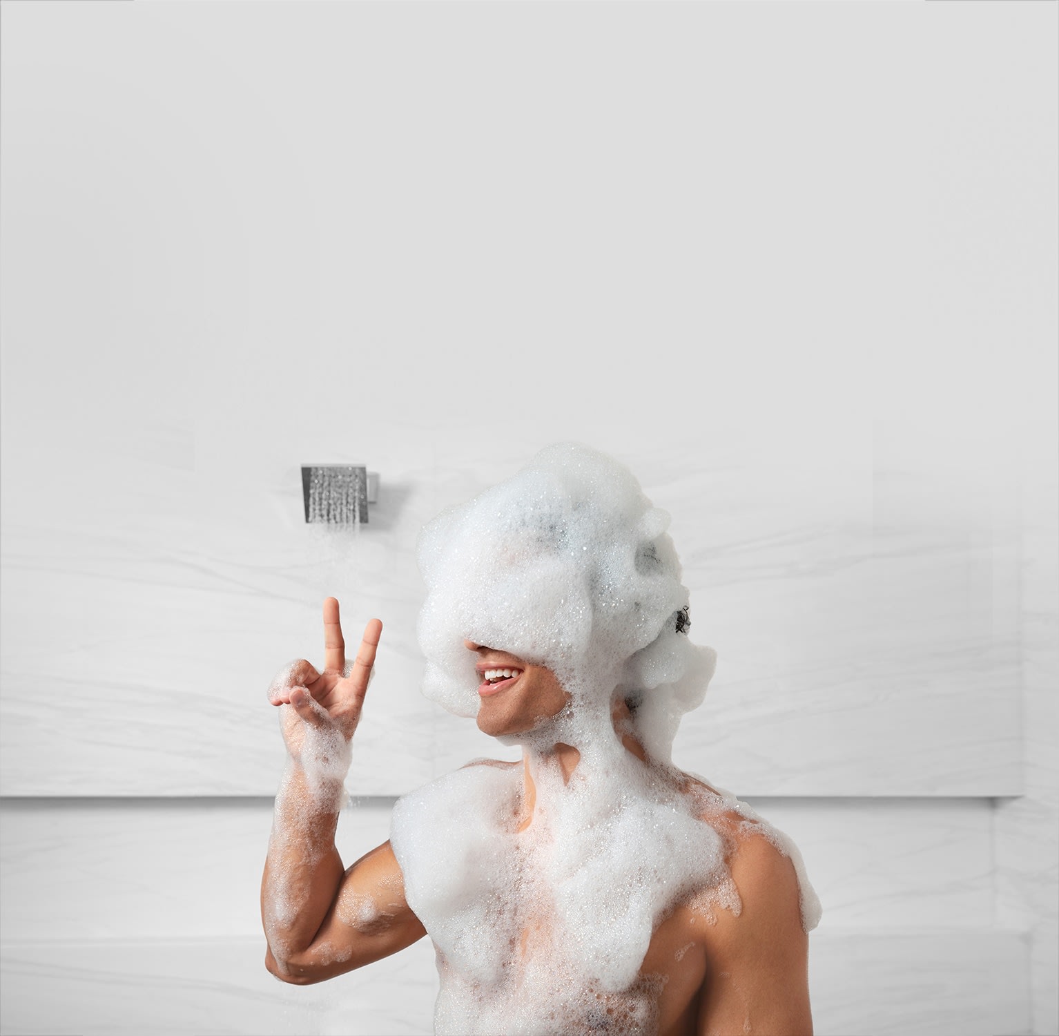 Male model covered in suds from the Refined® Body Wash for men