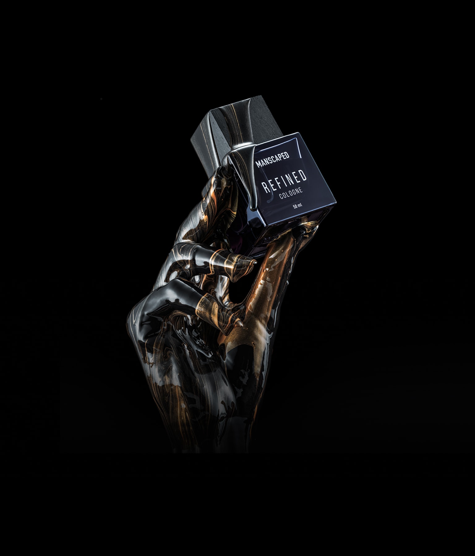 Refined® Cologne being held in the fingertips of a marbled hand